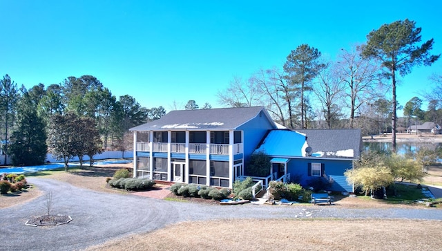 view of front of house with a water view and a sunroom