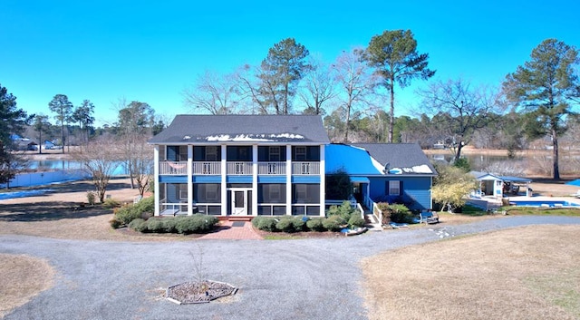 view of front of property with a sunroom and a balcony