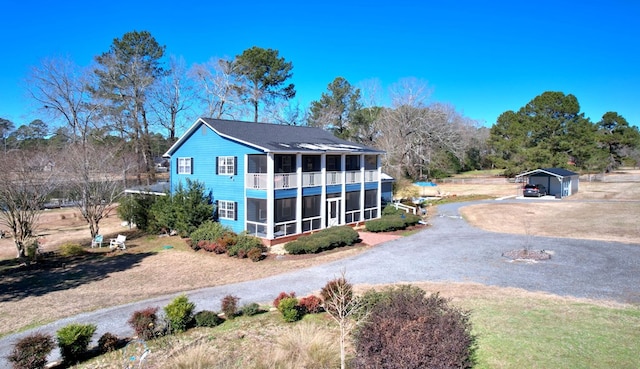 rear view of property with a sunroom