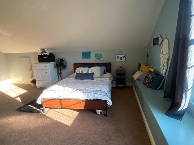 bedroom featuring dark carpet and lofted ceiling