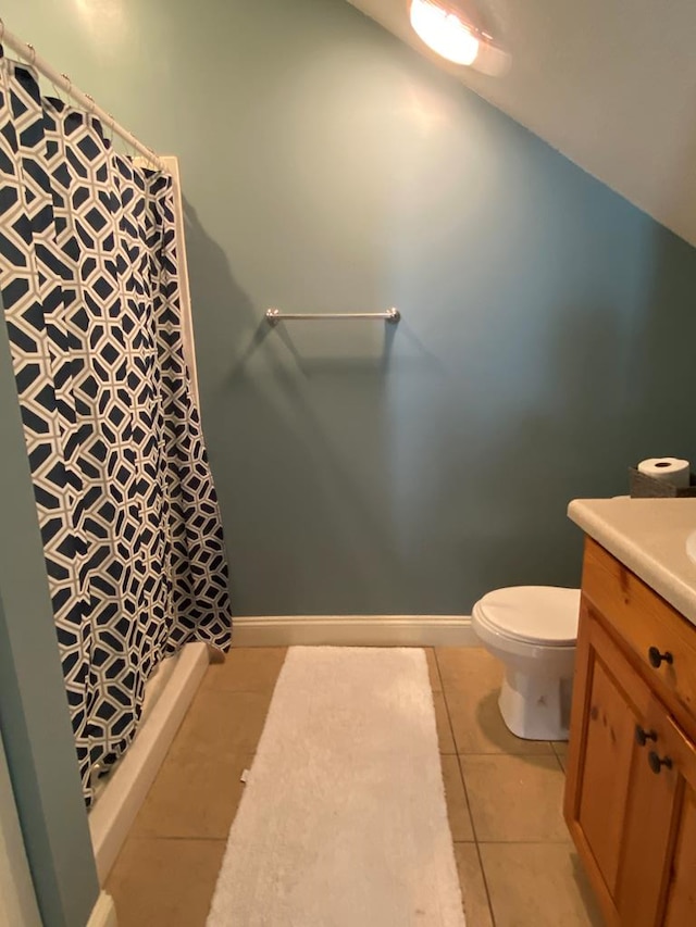 bathroom with walk in shower, toilet, tile patterned floors, and vanity