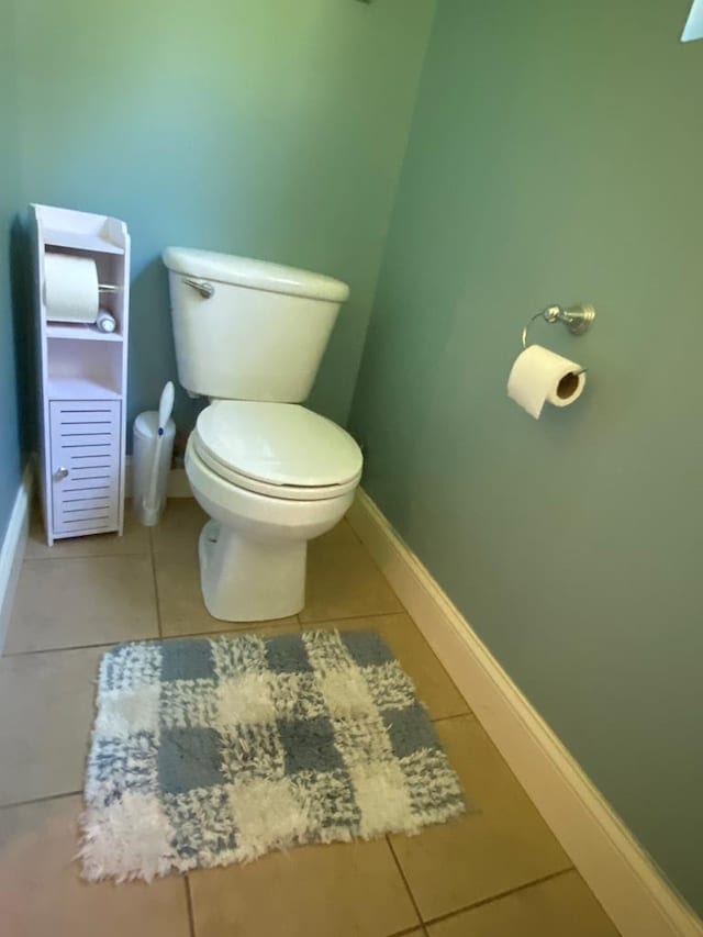 bathroom with toilet and tile patterned floors