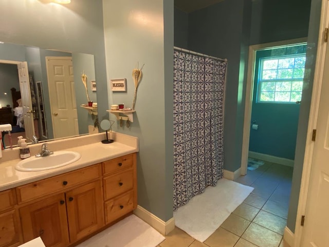 bathroom with curtained shower, tile patterned floors, and vanity