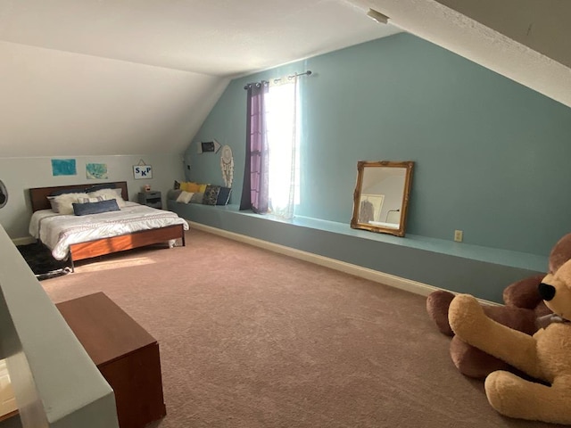 carpeted bedroom with lofted ceiling