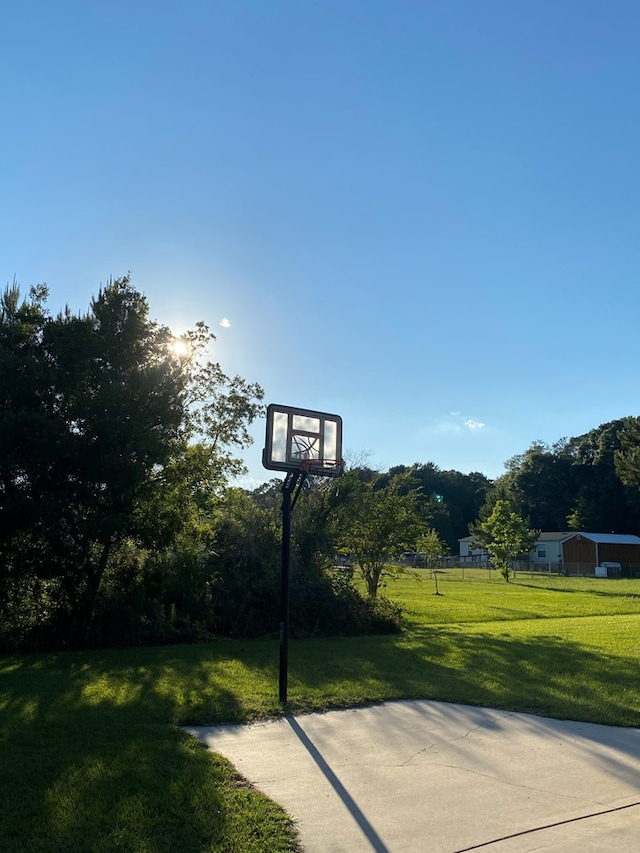 view of sport court featuring a yard