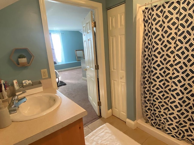 bathroom featuring walk in shower and vanity