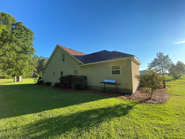 view of property exterior with a lawn and a storage shed