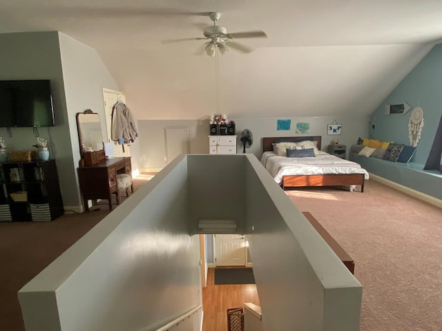 carpeted bedroom with vaulted ceiling and ceiling fan