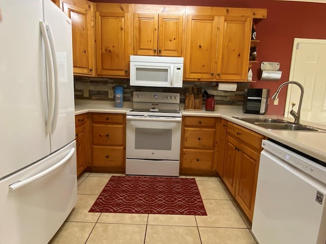 kitchen featuring sink, backsplash, white appliances, and light tile patterned floors