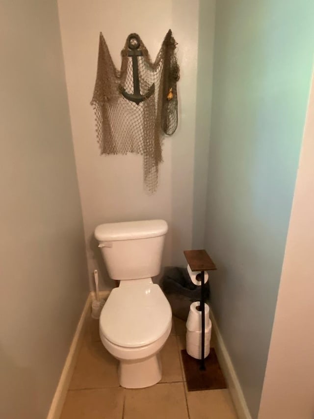 bathroom featuring toilet and tile patterned flooring