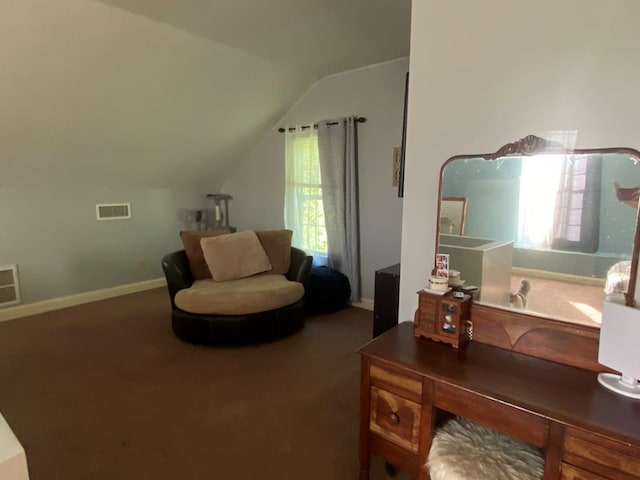 sitting room featuring vaulted ceiling and carpet flooring