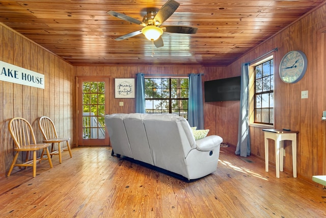 living room with wooden ceiling, light wood-type flooring, wooden walls, and ceiling fan