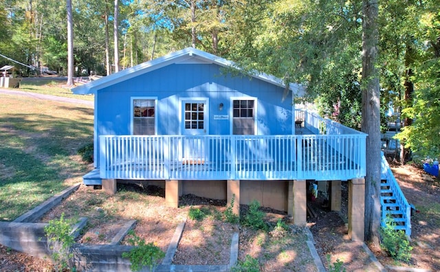 rear view of house featuring a wooden deck