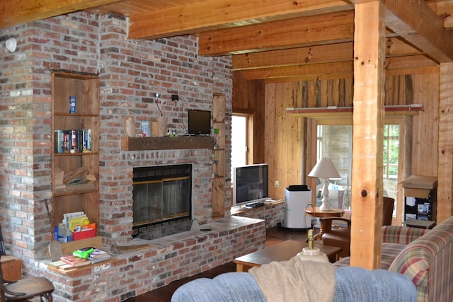 375 Flintside Dr, Cobb, GA 31735 - living room featuring healthy amount of natural light, a brick fireplace, wood walls, wood finished floors, and wood ceiling with exposed beams