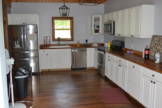 375 Flintside Dr, Cobb, GA 31735 - kitchen featuring appliances with stainless steel finishes, a sink, dark countertops, white cabinets, and dark wood-type flooring
