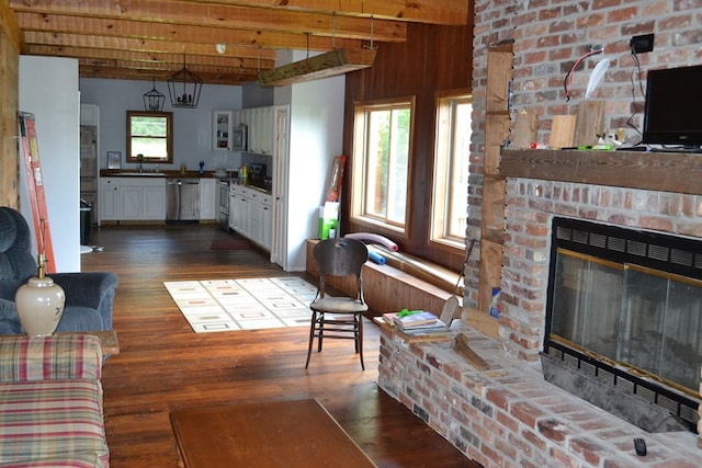 375 Flintside Dr, Cobb, GA 31735 - living area featuring beamed ceiling, dark wood-type flooring, and a fireplace