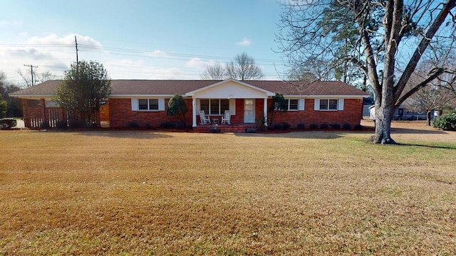 ranch-style house featuring a front yard and covered porch