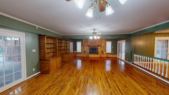 unfurnished living room with crown molding, ceiling fan, and wood-type flooring