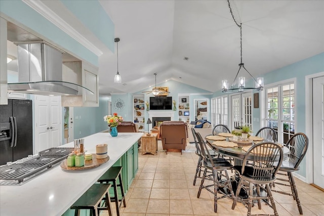 115 N Cedar Creek Rd, Cordele, GA 31015 - dining area featuring vaulted ceiling, a fireplace, light tile patterned flooring, a chandelier, and a ceiling fan