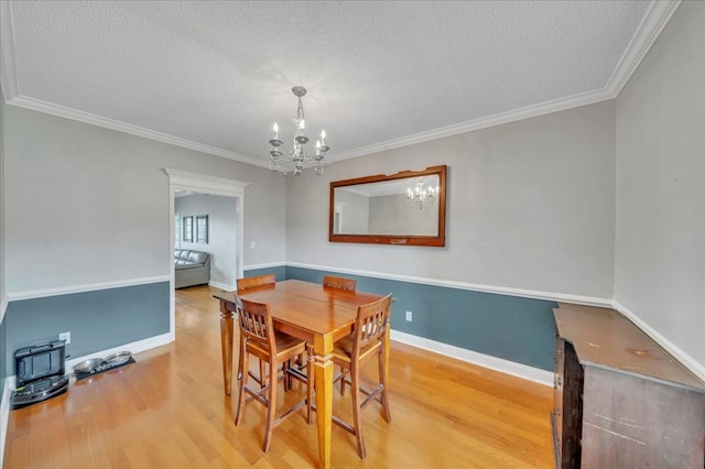 1942 Antioch Rd, Cordele, GA 31015 - dining space with wood finished floors, a textured ceiling, a chandelier, crown molding, and baseboards