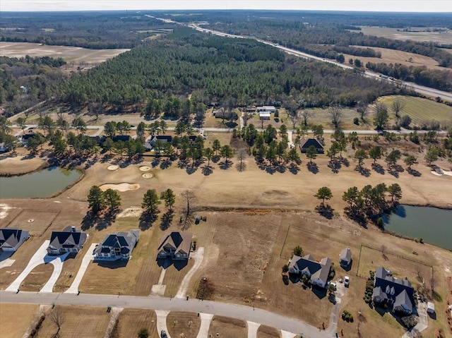 birds eye view of property with a water view and a rural view