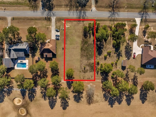 birds eye view of property with a rural view