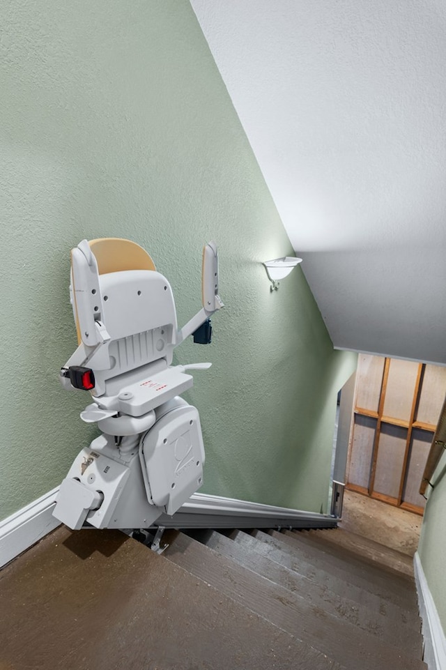 stairway featuring vaulted ceiling