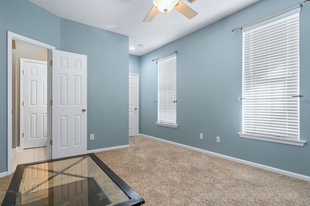 unfurnished bedroom with ceiling fan and carpet flooring