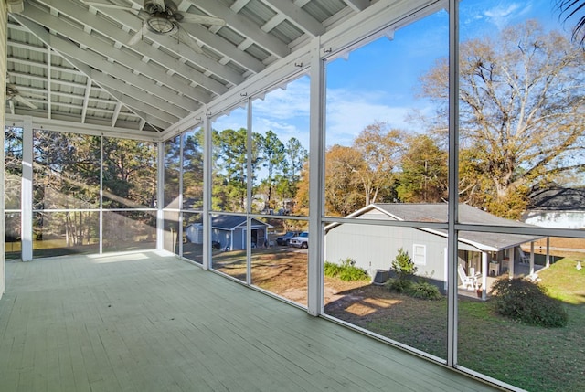 unfurnished sunroom featuring ceiling fan