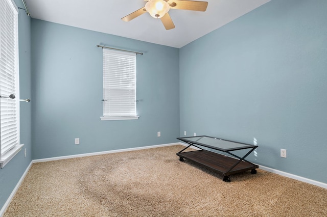 spare room featuring ceiling fan and carpet flooring