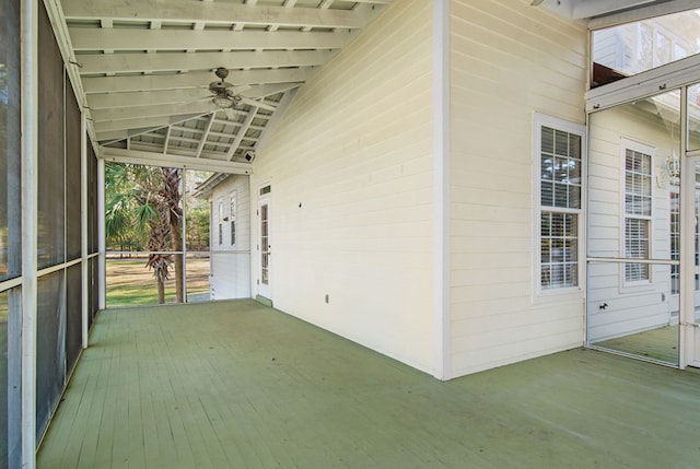 unfurnished sunroom featuring vaulted ceiling and ceiling fan