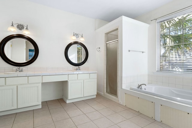 bathroom with tile patterned floors, vanity, and independent shower and bath