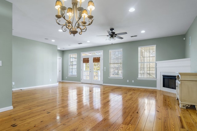 unfurnished living room with light hardwood / wood-style floors, ceiling fan, and french doors