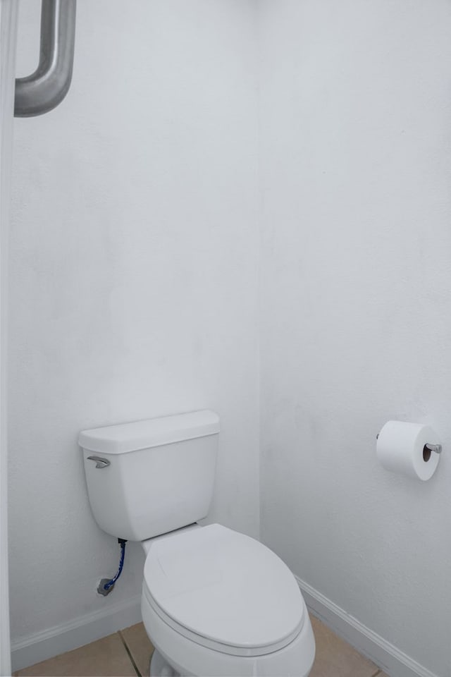 bathroom with toilet and tile patterned flooring