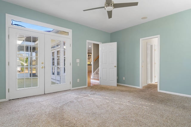 empty room with carpet floors, a wealth of natural light, and french doors