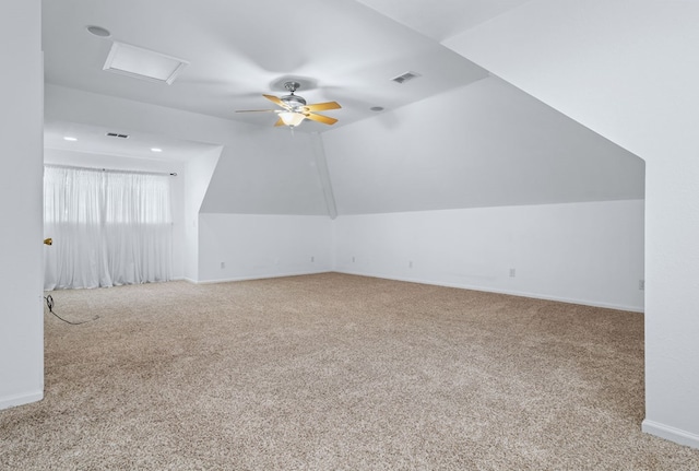 additional living space featuring ceiling fan, light carpet, and vaulted ceiling