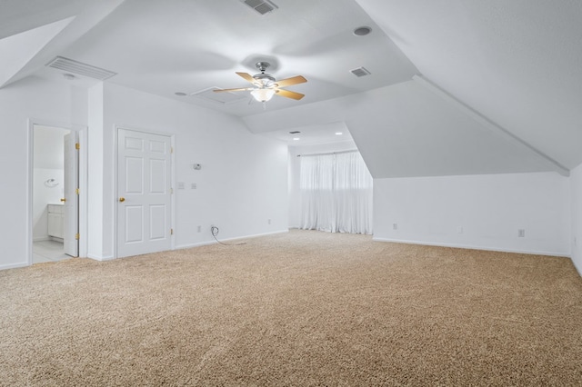 additional living space featuring ceiling fan, light carpet, and lofted ceiling