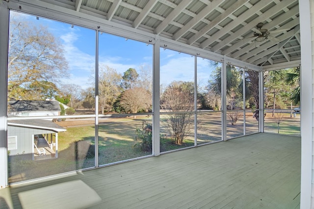 unfurnished sunroom featuring ceiling fan