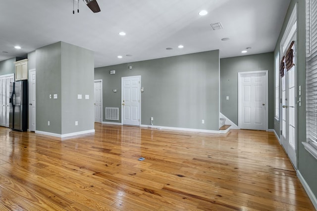 unfurnished living room featuring light hardwood / wood-style floors and ceiling fan