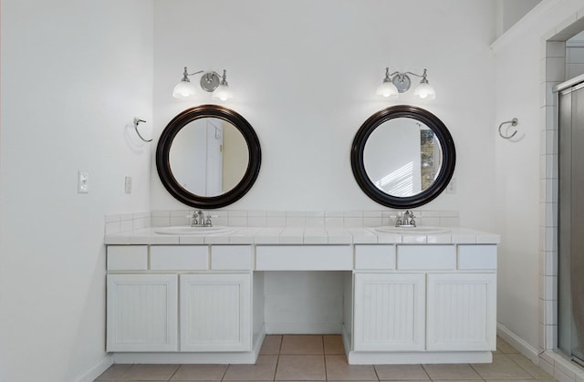 bathroom featuring tile patterned floors, vanity, and walk in shower