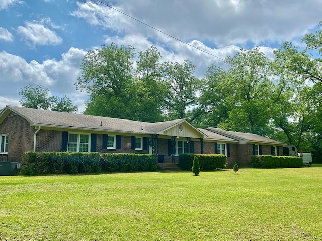 ranch-style home with a front lawn and brick siding
