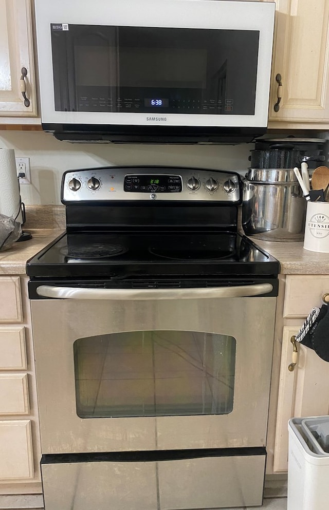 interior details featuring stainless steel electric stove and light countertops