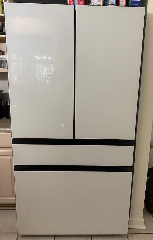 room details featuring white fridge and white cabinets