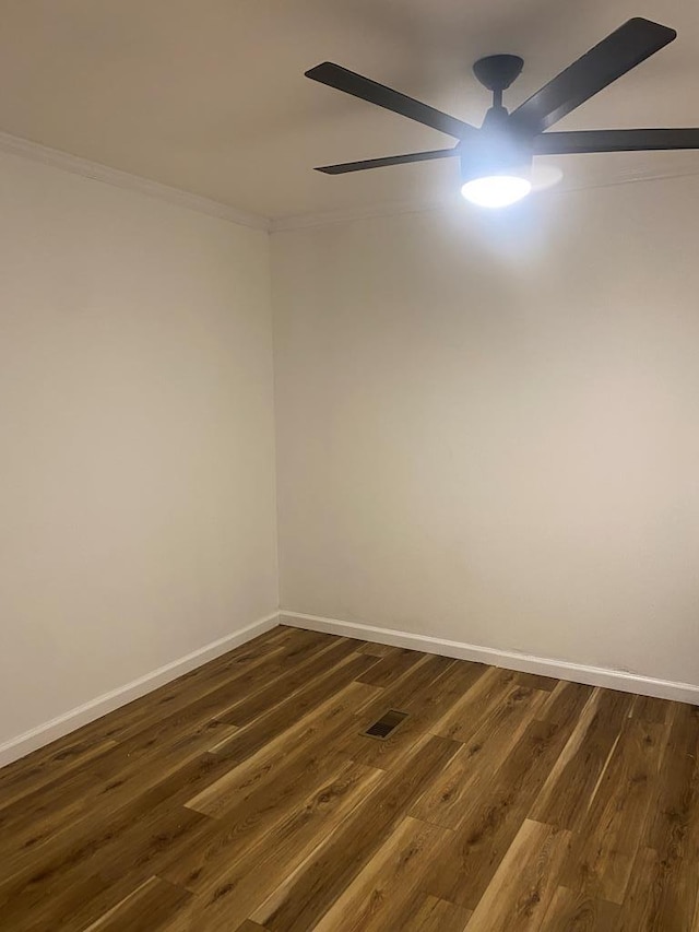 unfurnished room featuring baseboards, visible vents, ornamental molding, and dark wood-style flooring