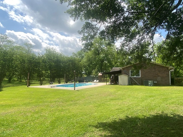 exterior space with an outdoor structure, cooling unit, and a fenced in pool