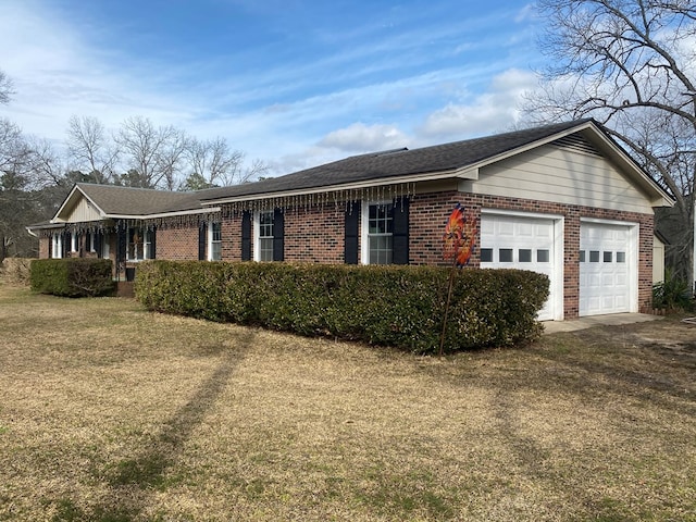 view of front of property with a garage and a front lawn