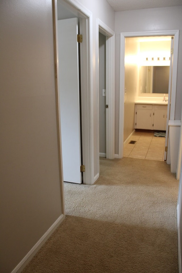 101F Country Club Dr, Americus, GA 31709 - corridor with carpet, baseboards, and tile patterned floors