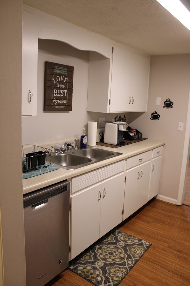 101F Country Club Dr, Americus, GA 31709 - kitchen with dishwasher, a sink, wood finished floors, and light countertops