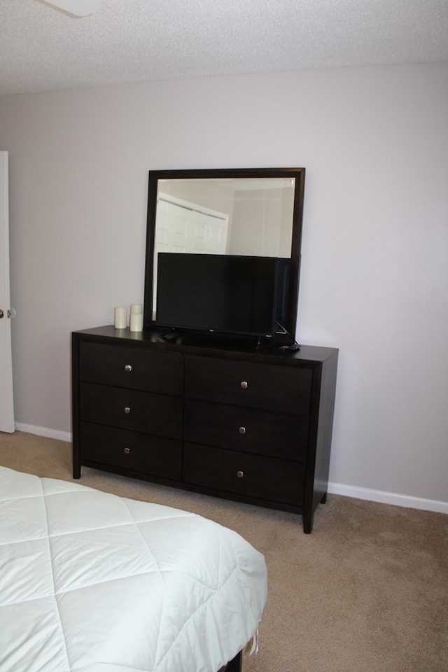 101F Country Club Dr, Americus, GA 31709 - bedroom with light carpet, a textured ceiling, and baseboards
