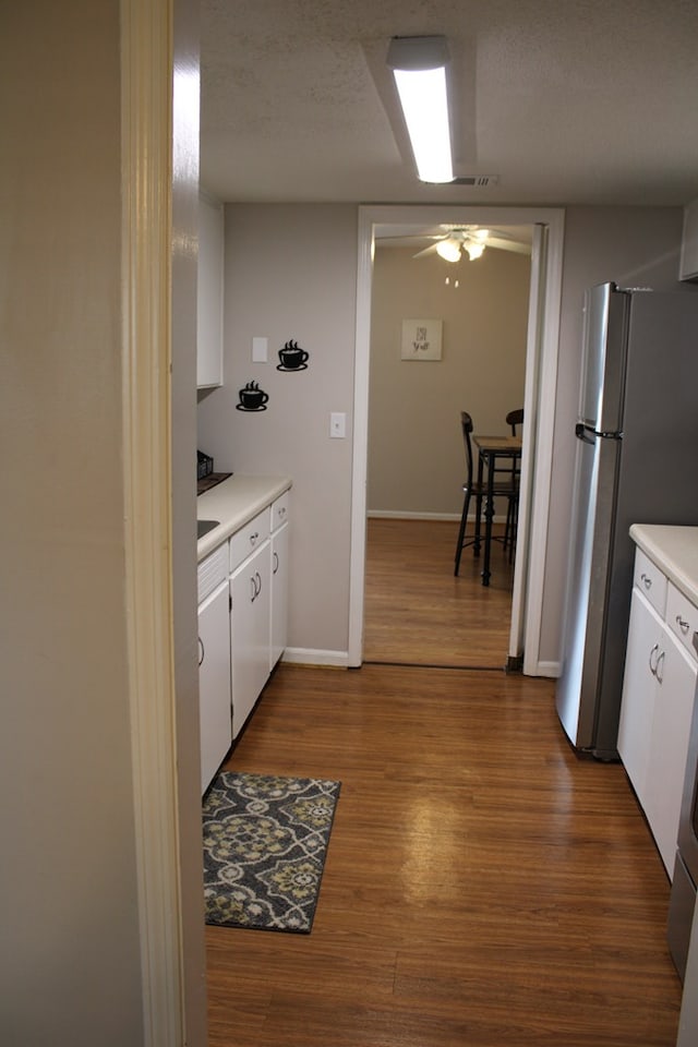 101F Country Club Dr, Americus, GA 31709 - kitchen featuring ceiling fan, light countertops, white cabinetry, and dark wood-type flooring